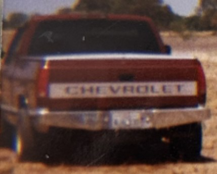 1994 red Chevrolet 1500, silver bed cover (1994–1999)